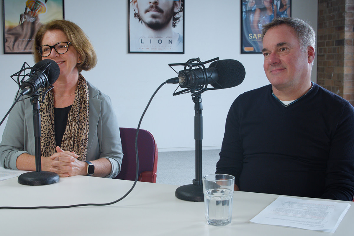 Michele McDonald and Graeme Mason sitting at a table recording the Screen Australia podcast.