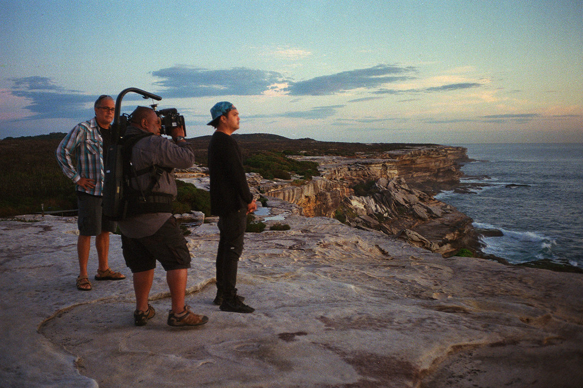 Shooting on a clifftop overlooking the ocean, a look behind the scenes of documentary Looky Looky Here Comes Cooky