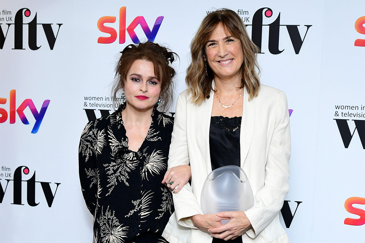 Helena Bonham Carter and Jessica Hobbs stand in front of the media wall at the Women in Film and TV Awards