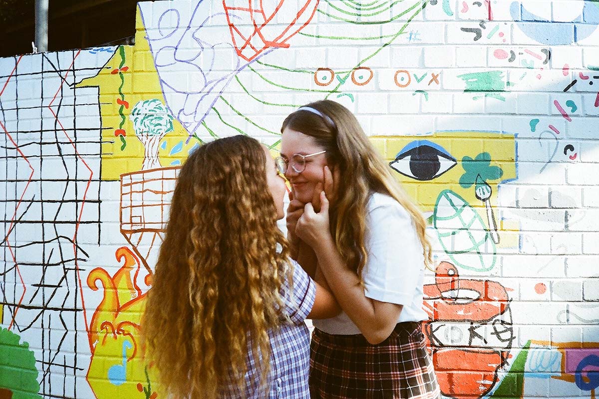 Production still from The Formal. Two girls embrace.