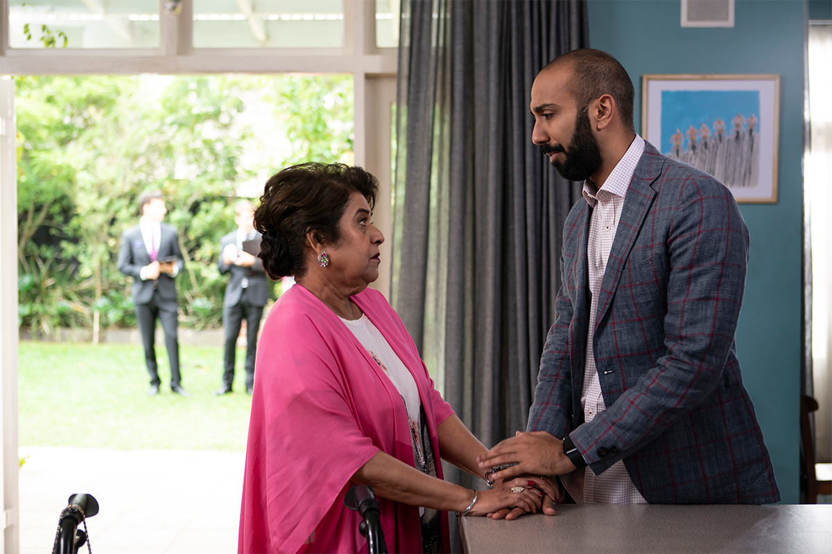 Manju and Harry hold hands in Five Bedrooms.