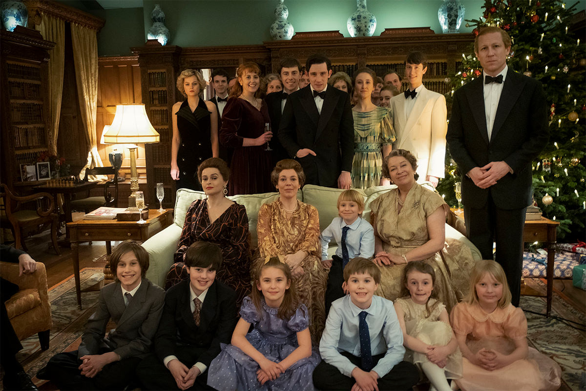 The Crown still, the Royal Family pose for a photo in front of a Christmas Tree