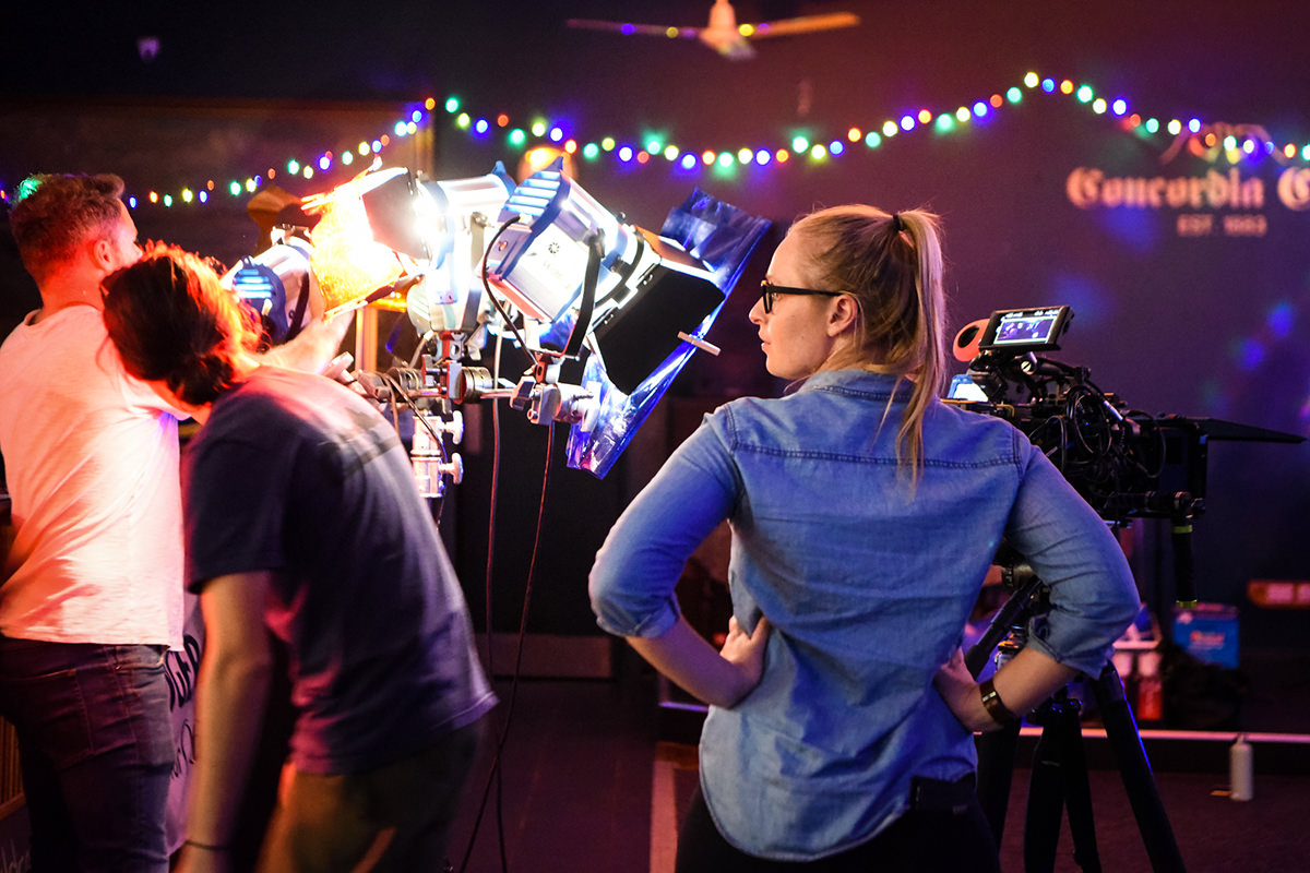 Writer/director Monica Zanetti stands behind a camera on the set of Ellie & Abbie (& Ellie's Dead Aunt)