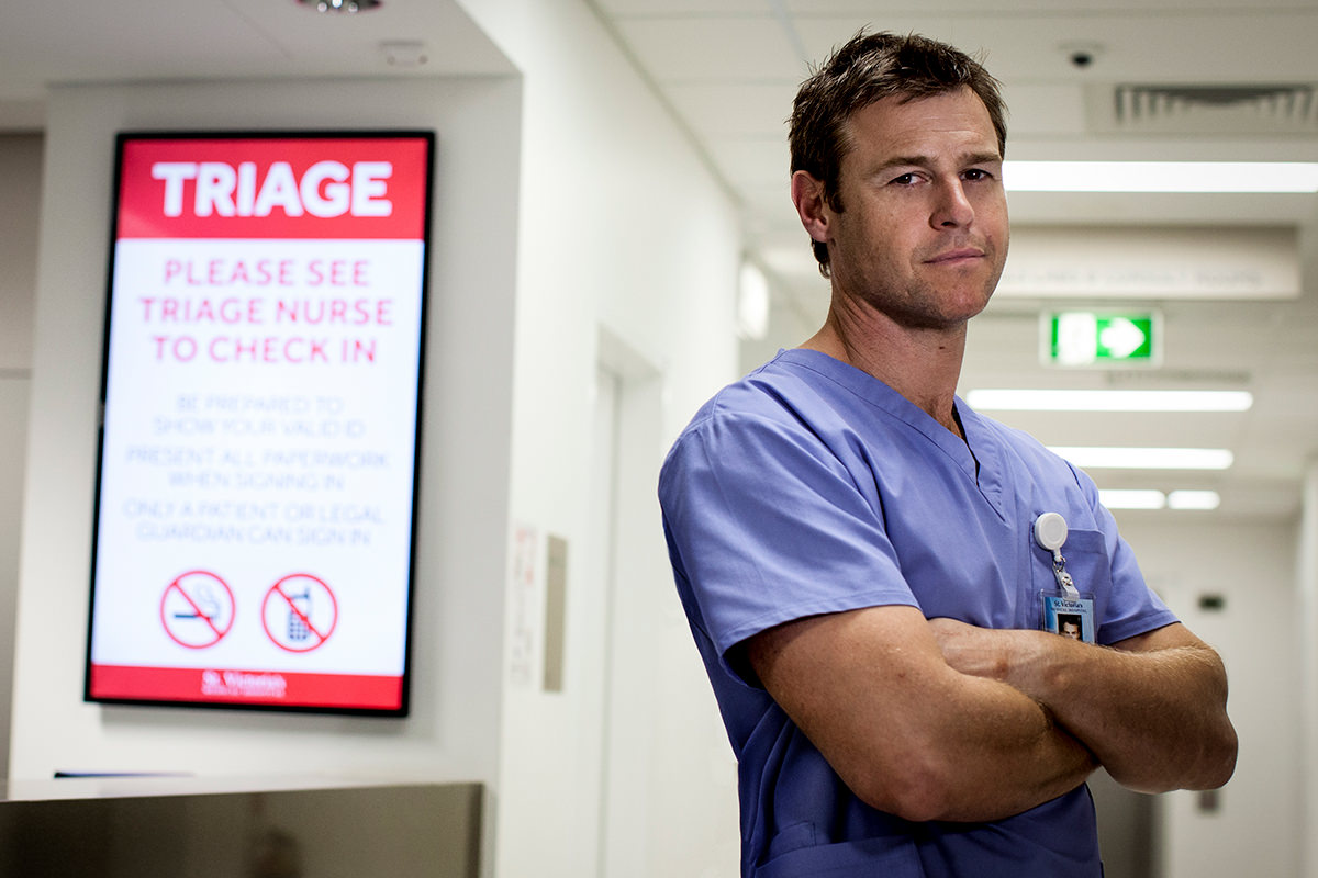 Production shot from TV series Doctor Doctor. Doctor stands next to a Triage sign in a hospital