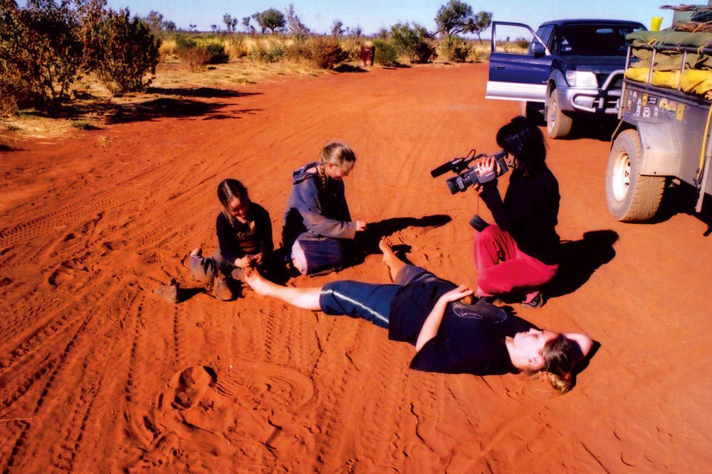 A group of people on a dirt road