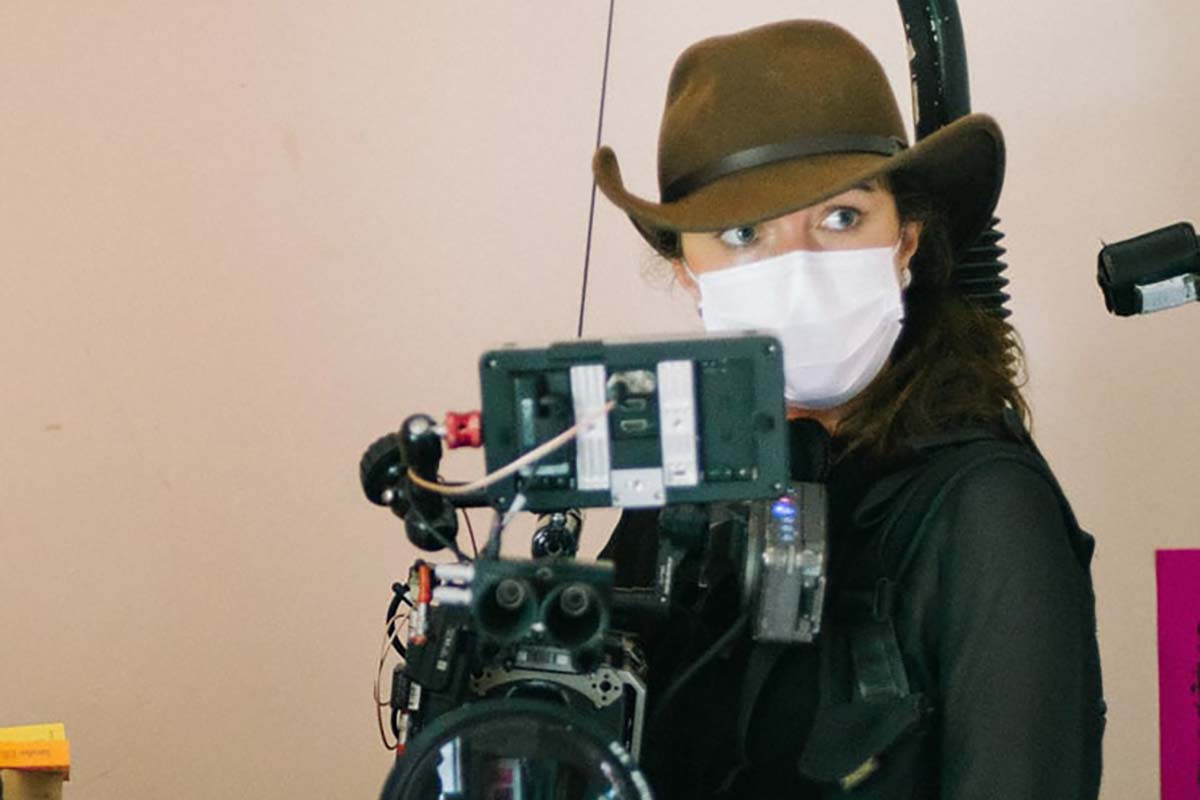 Ashley Barron holding a camera on the set of The Tailings