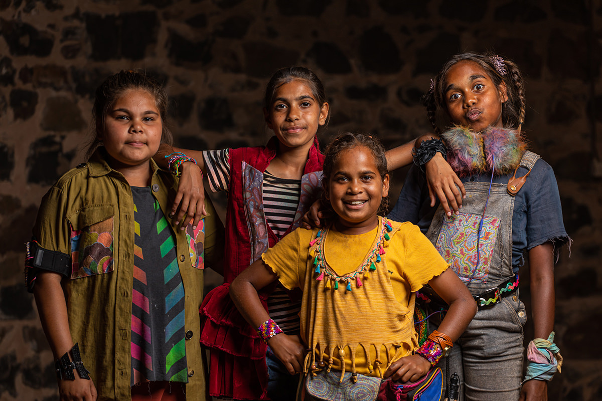 Four children posing and smiling at the camera