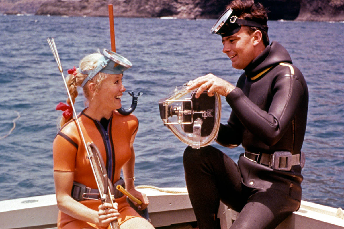 Valerie and Ron Taylor sit on a boat.